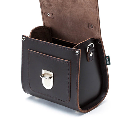 Versatile Dark Brown Sugarcube Handbag modeled as a stylish clutch, highlighting its elegant design and premium leather material.
