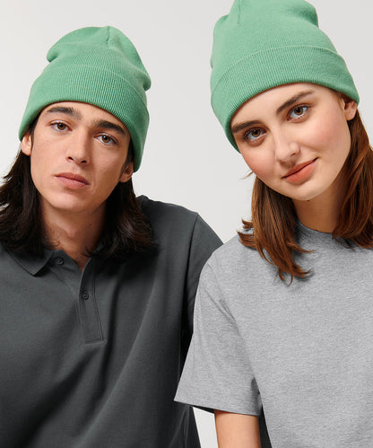 Luxury unisex ribbed beanie made from organic cotton and recycled polyester, featuring a foldable brim, available in various elegant colours.