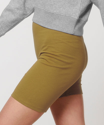 Flat lay of luxury organic cotton biker shorts in various sizes, representing sustainable fashion choices for the modern woman.