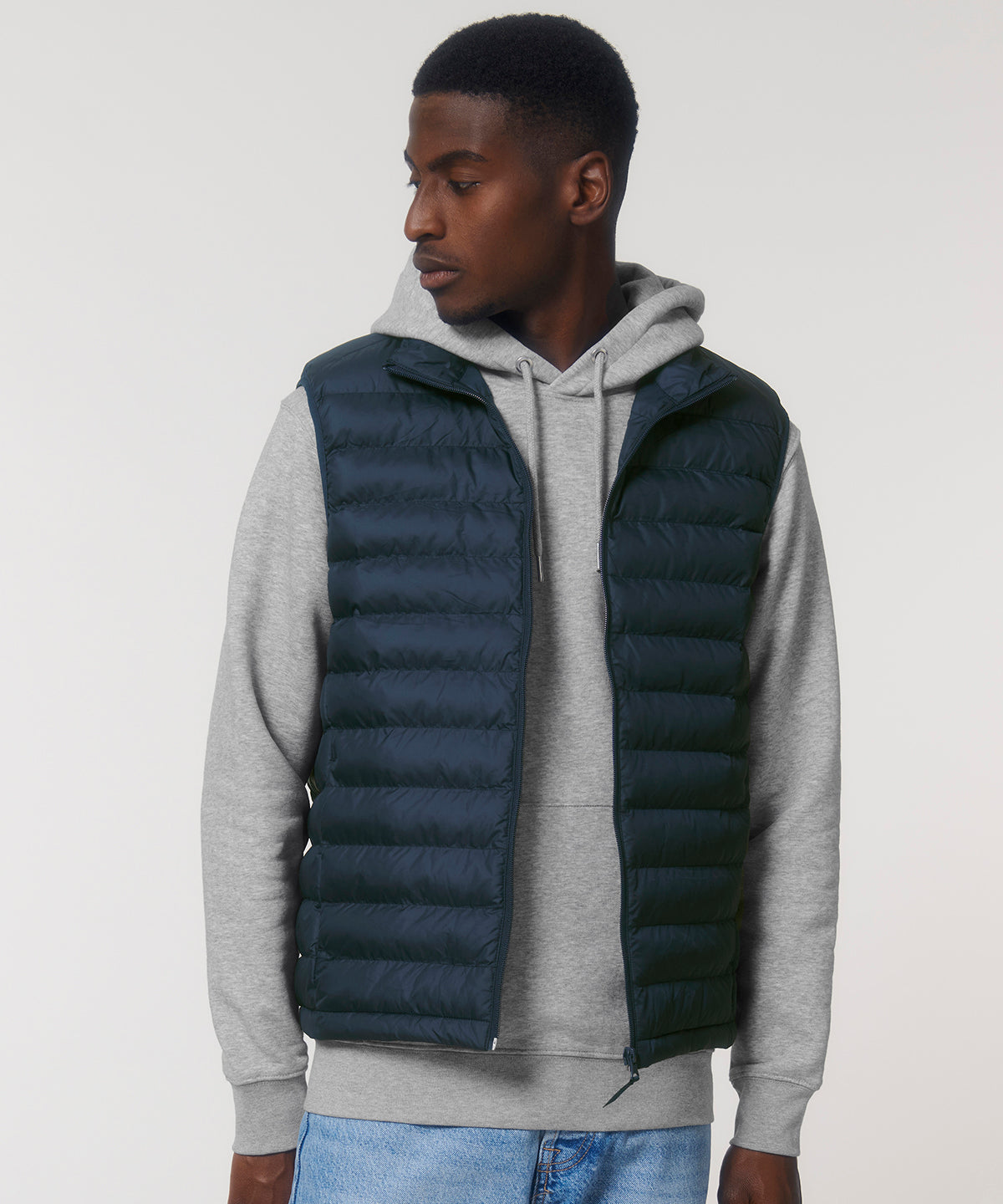Mens puffer bodywarmer worn casually, illustrating how this sustainable piece enhances comfort and style in every ensemble.