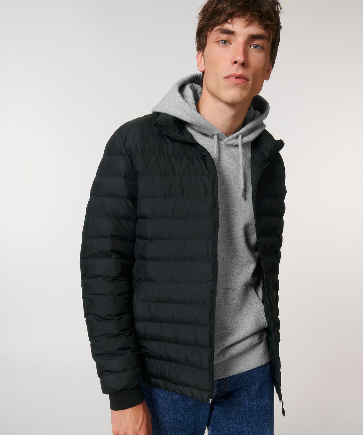 Luxurious eco-friendly men's puffer jacket crafted from 100% recycled polyester, featuring a detachable hood for style and versatility.