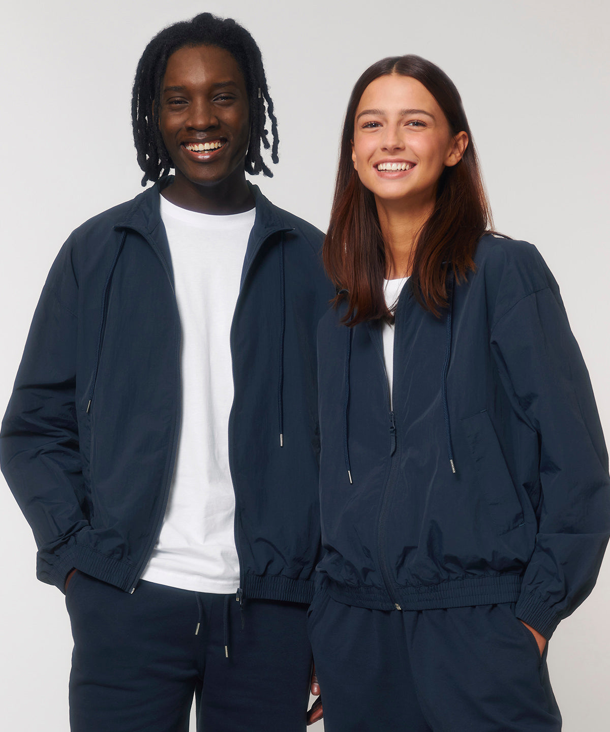 Luxurious lightweight unisex recycled nylon tracksuit top, perfect for sports and casual styles, featuring elegant design for both comfort and performance.