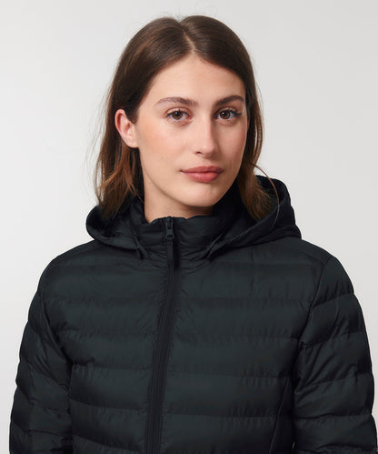 Close-up view of the luxurious women's puffer jacket made from recycled polyester, showcasing the adjustable hem and exquisite stitching details.