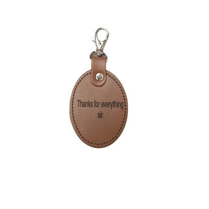 Elegant oval leather bag charm, perfect for teacher appreciation gifts, featuring high-quality leather and custom engraving service.