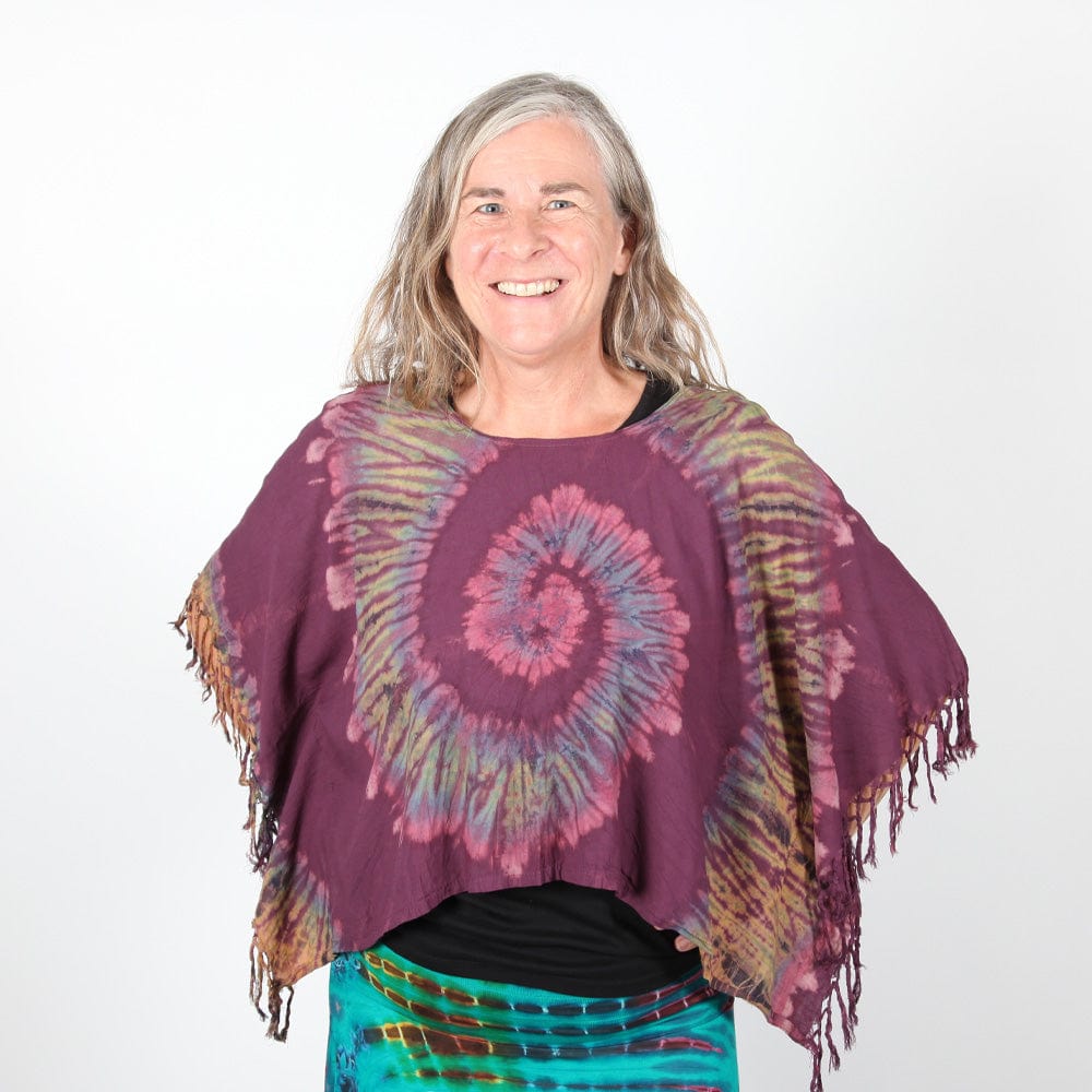Styled appearance of the Luxury Tie Dye Cropped Poncho worn over trendy high-waisted jeans, demonstrating its versatile fit for UK dress sizes 8-16.