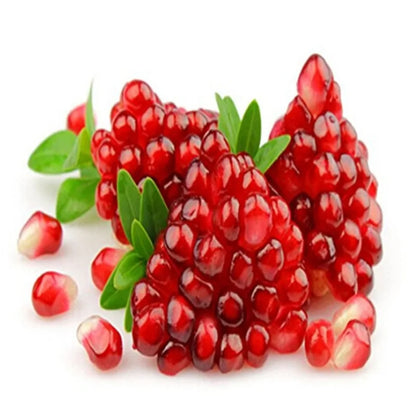 Luxurious pomegranate seeds glistening with a rich ruby hue, nestled among vibrant green leaves, showcasing the delicious and nutritious treasures of nature.