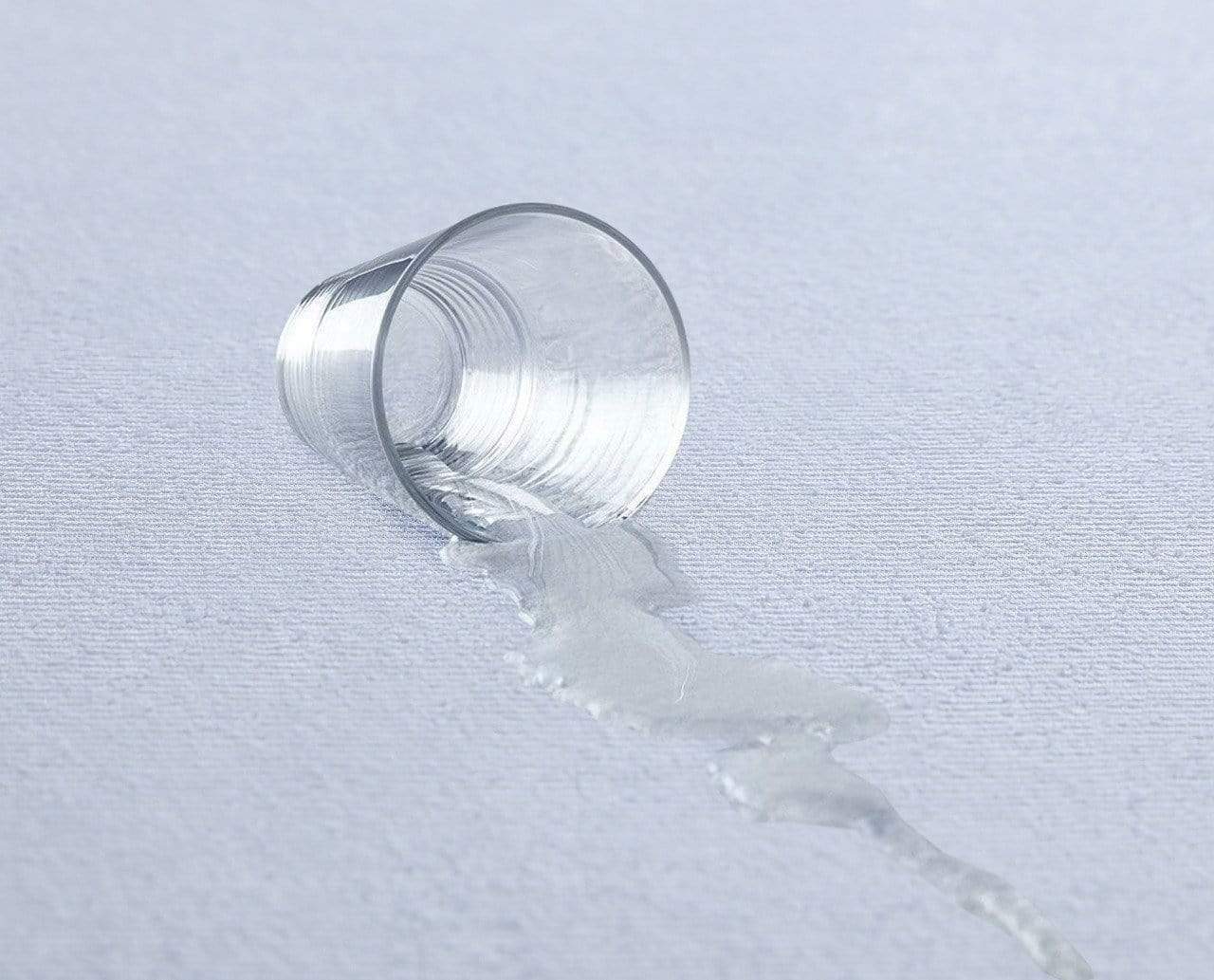 Close-up of the highly absorbent cotton terry fabric of the mattress protector, showcasing its plush texture and water-resistant properties.