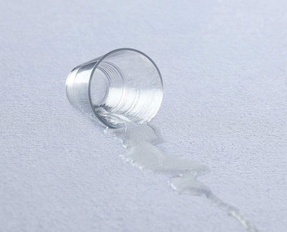 Close-up of the highly absorbent cotton terry fabric of the mattress protector, showcasing its plush texture and water-resistant properties.