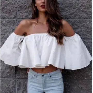 Stunning white chiffon blouse with an off-shoulder design, elegantly draping over a model against a textured grey wall.