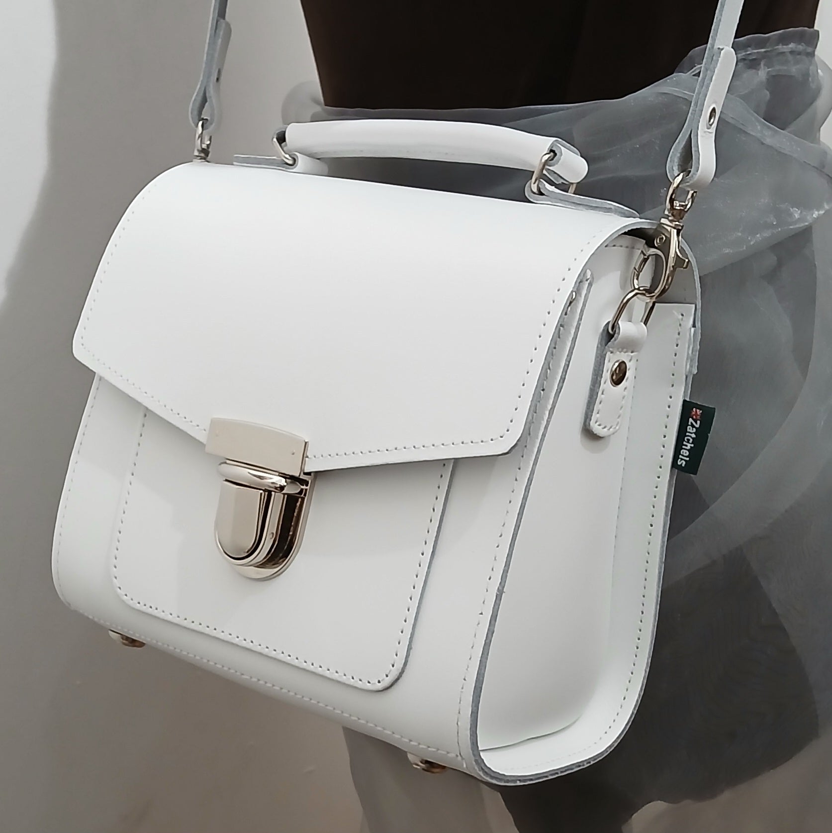 Impeccably crafted Handmade White Leather Sugarcube Handbag in a pristine white finish, exemplifying fine craftsmanship and an essential accessory for fashion-forward individuals.