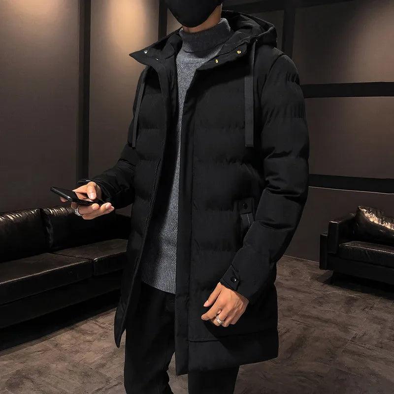 A model wearing a stylish mid-length padded jacket in grey, demonstrating its perfect fit and modern silhouette for a sophisticated winter look.