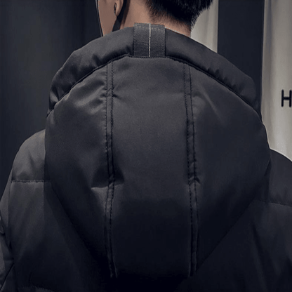 Elegant men's mid-length hooded padded jacket in grey, featuring a sleek silhouette and practical side pockets, suitable for both leisure and sophisticated wear.