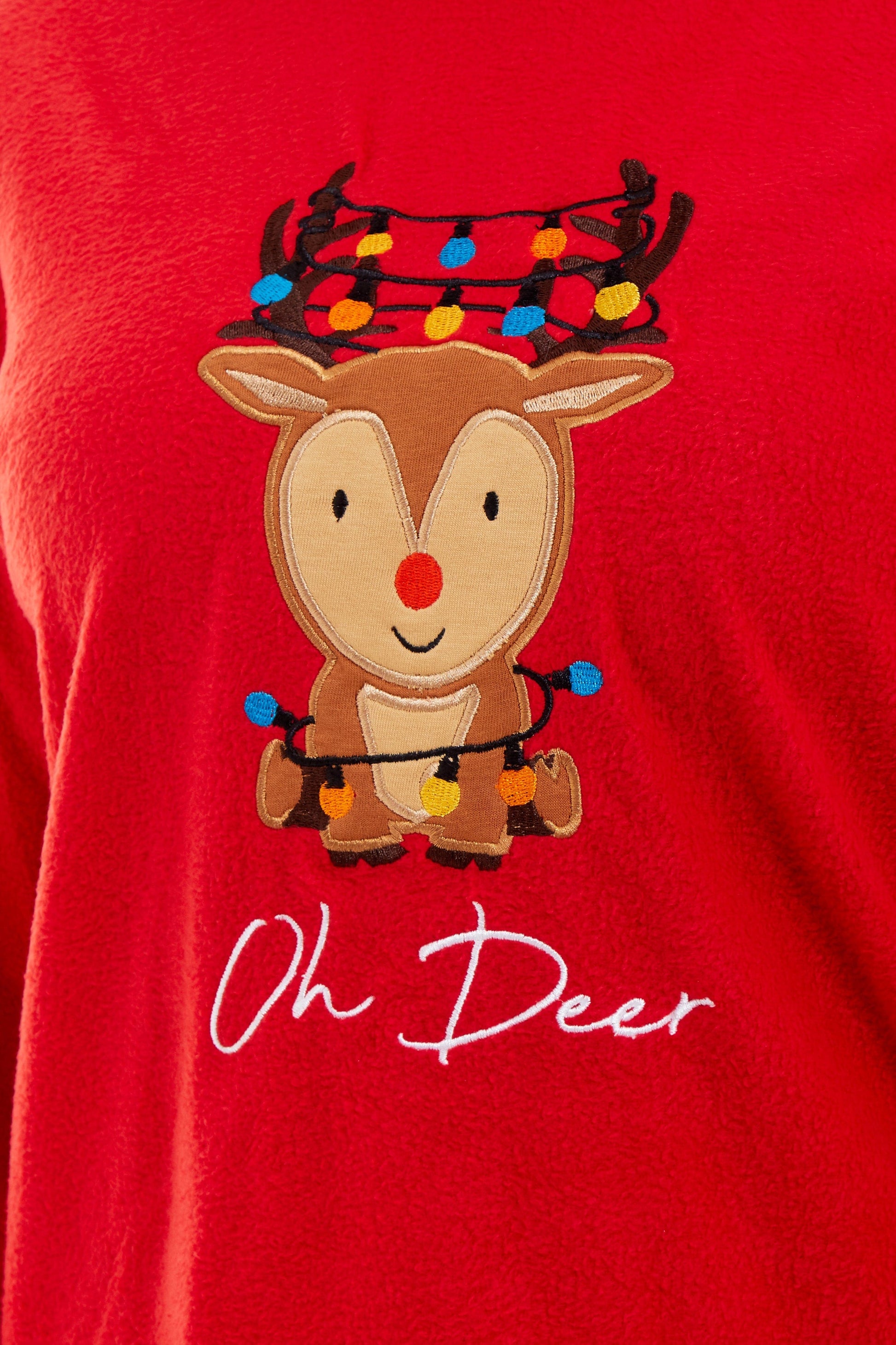 Stylish contrasting patterned bottoms of Women's Ultra-Soft Polar Fleece Pyjama Set featuring elegant festive reindeer motif, ideal for sophisticated winter lounging.