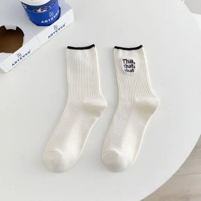 Sophisticated Elegant White Embroidered Socks for Women, showcasing a unique Japanese-style font design in black, artistically arranged on a chic table setting.