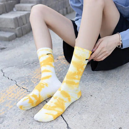 Luxurious Women's Tie-Dye Middle Tube Socks in bright yellow, showcasing an eye-catching design, perfect for enhancing any outfit with vibrant comfort.