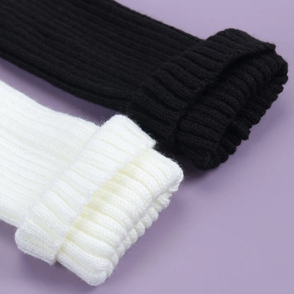 Close-up of Luxury Long Socks Women's Leg Warmers in black and white, highlighting the luxurious feel and stylish ribbed edges.