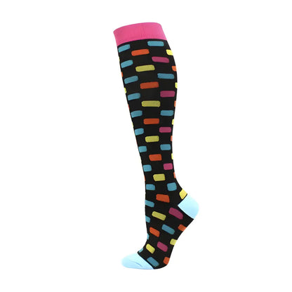 Chic women's knee length compression travel socks with a playful multicoloured pattern on a black background, perfect for enhancing style while ensuring comfort.