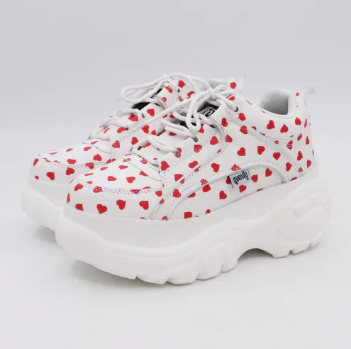 Elegant white platform sneaker with intricate detailing, showing off style and comfort in every step.